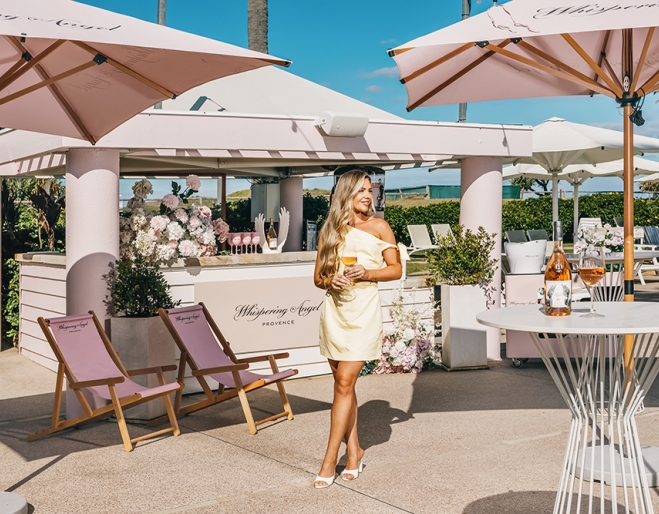 Woman holding wine at bar of Whispering Angel Activation Pop-Up Sheraton Grand Mirage Resort