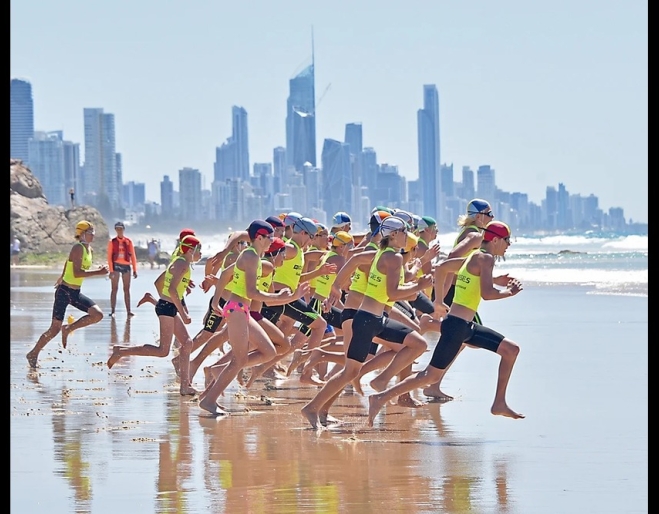 Competitors competing with Gold Coast buildings in backgroundAustralian Surf Life Saving Championships 2025