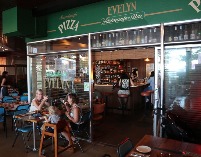 People seated at entrance of Bar Evelyn Coolangatta
