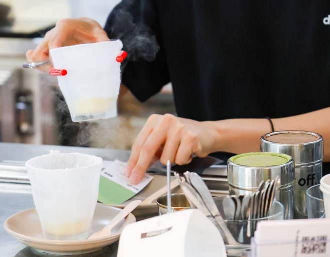 Girl making coffees behind a counter, Day Off Southport 