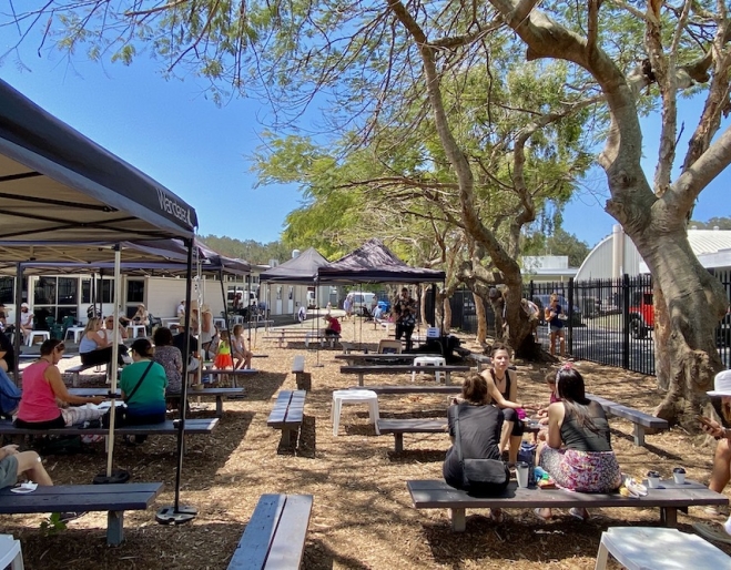 People outside on tables at Palm Beach Farmers' Market, Palm Beach