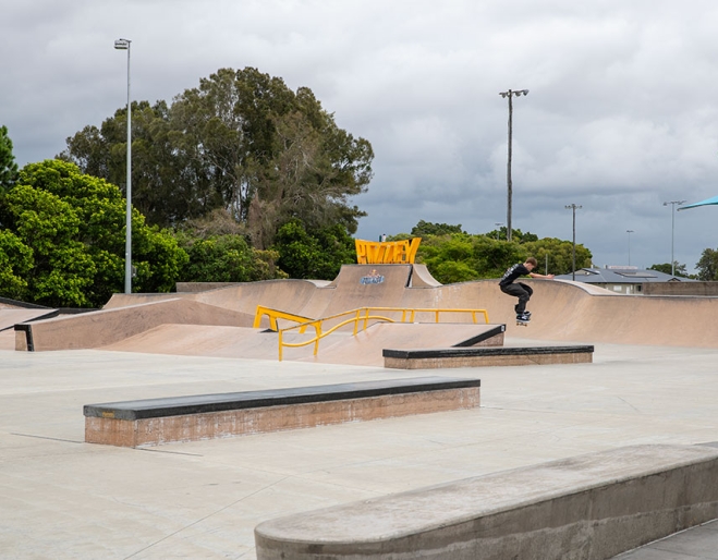 Skate park with jumps and sign