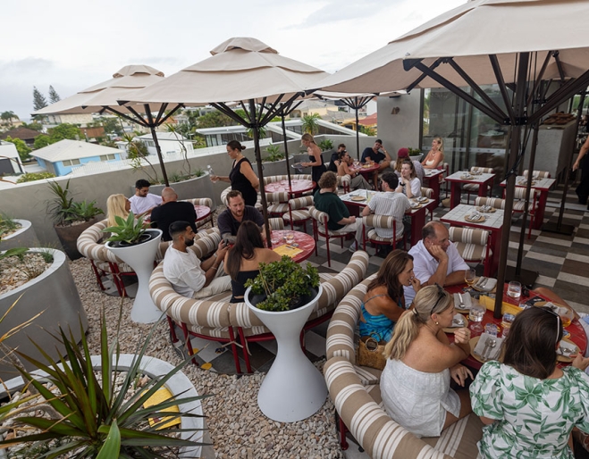 people on rooftop at Nobby Beach