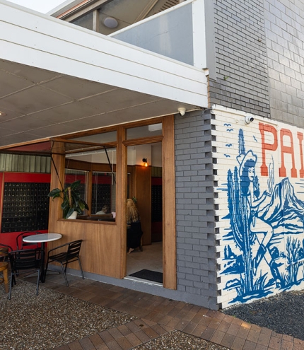 Side view with mural of Palomino's Deli