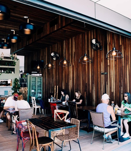 People seated at entrance of Rise & Set Coombabah