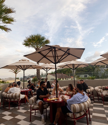 People sitting on al fresco terrace at Sueño Rooftop Nobby Beach