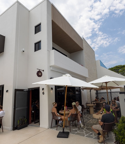 Velvet Cafe & Lounge's building with people sitting outside 