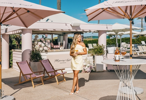 Woman holding wine at bar of Whispering Angel Activation Pop-Up Sheraton Grand Mirage Resort