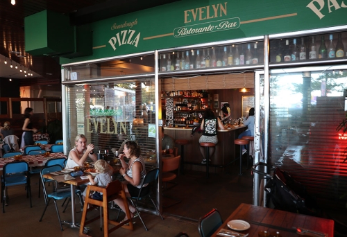 People seated at entrance of Bar Evelyn Coolangatta