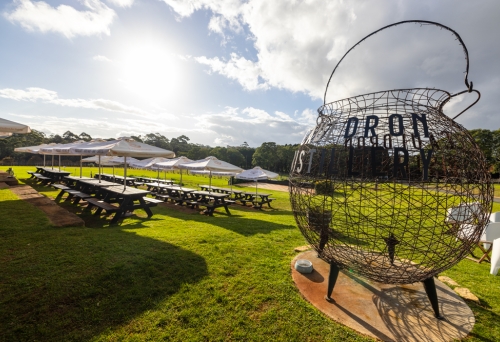 Picnic tables on the grass outside Cauldron Distillery Tamborine Mountain 