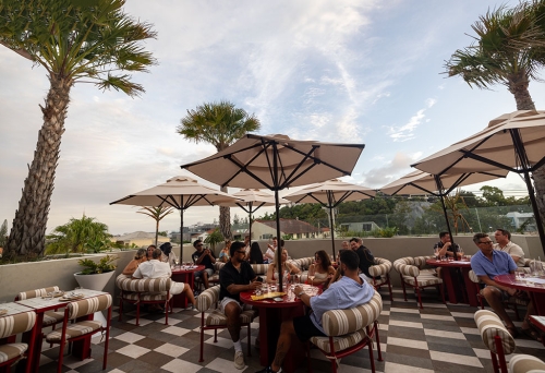 People sitting on al fresco terrace at Sueño Rooftop Nobby Beach