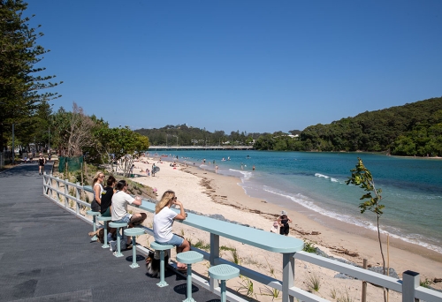 People seated on stools on Tallebudgera Boardwalk