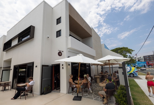 Velvet Cafe & Lounge's building with people sitting outside 