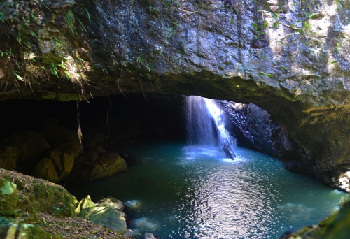 Light shining through waterfall cave Natural Bridge