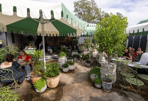 People seated in garden at Tarte Tea Garden
