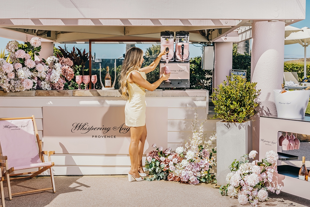 Woman at bar of Whispering Angel Pop-Up Activation Sheraton Grand Mirage Resort