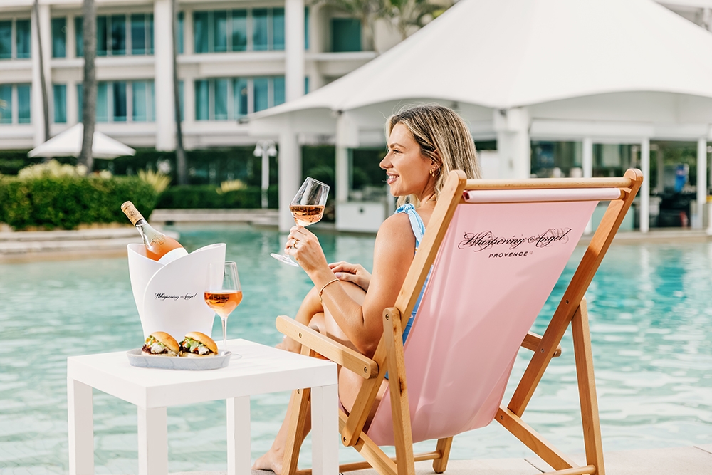 Woman holding rosé poolside at the Whispering Angel Activation Pop-Up Sheraton Grand Mirage Resort