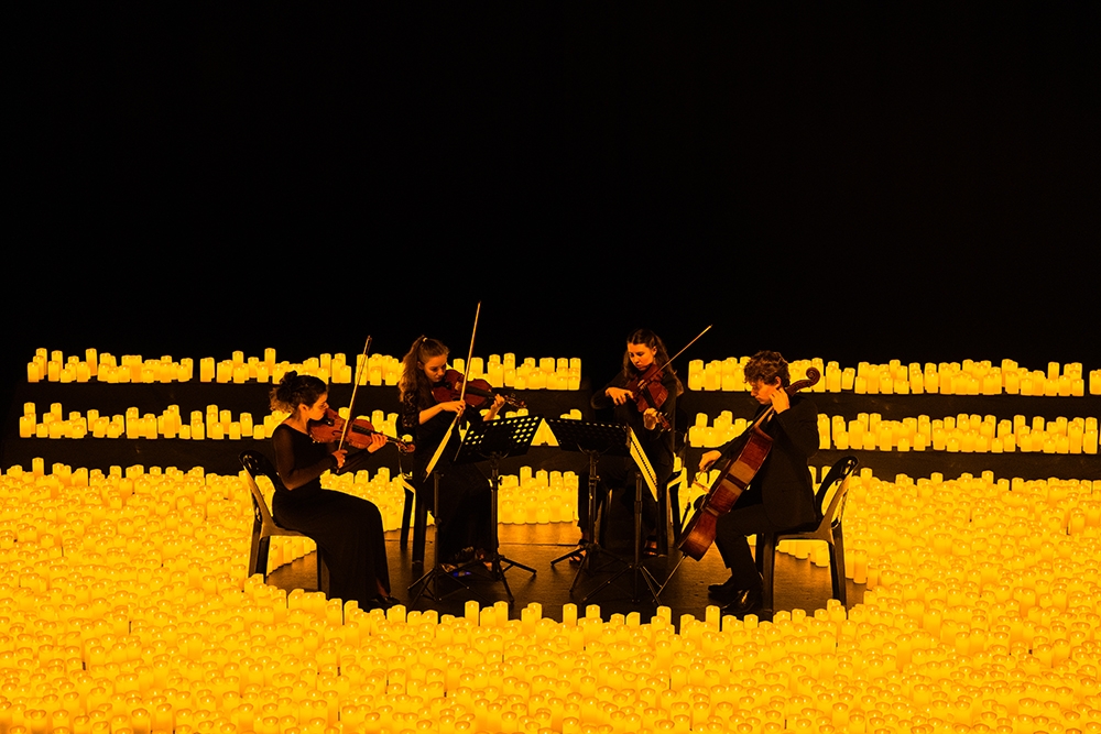 Musicians surrounded by candles at Candlelight: Best of Bridgerton on Strings, Imperial Hotel, Main Beach