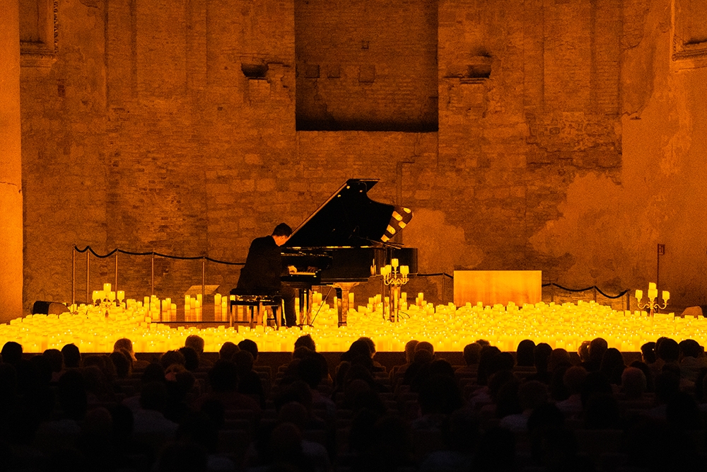 Piano on stage surrounded by candelight at Candlelight: Best of Bridgerton on Strings, Imperial Hotel, Main Beach