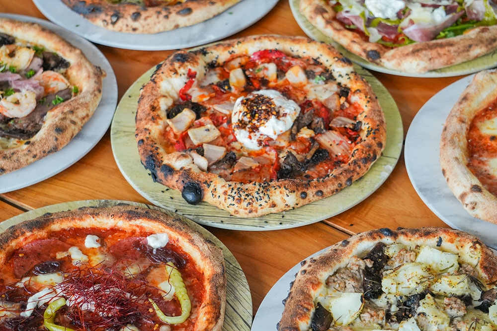Table of pizzas at Aviary Rooftop