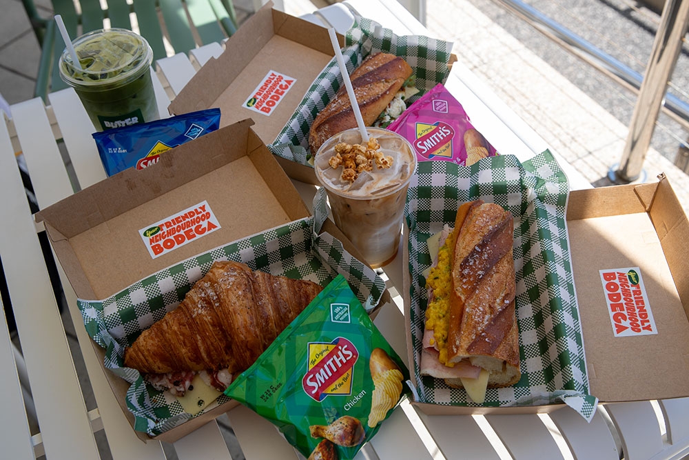 Baguettes, croissant, chips and drinks on table