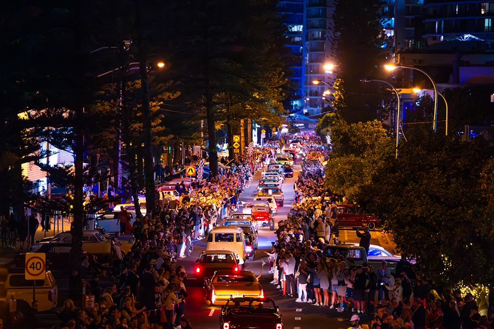Row of classic cars driving at night at Cooly Rocks On 2026