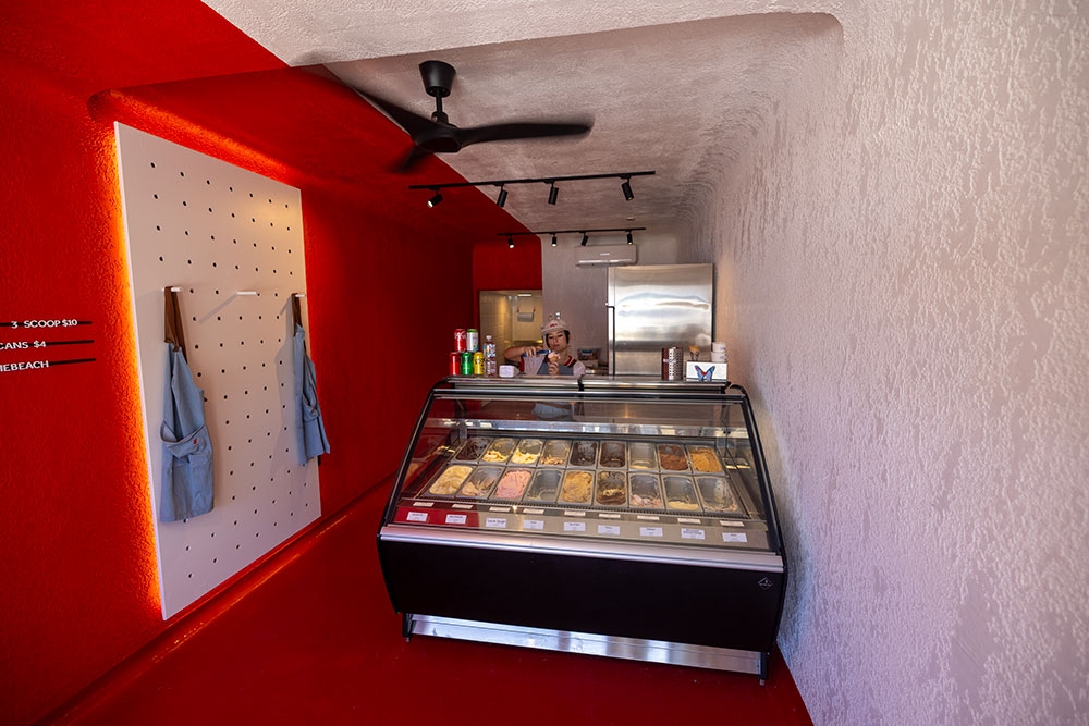 Red wll and ice cream counter inside Elly's Gelato