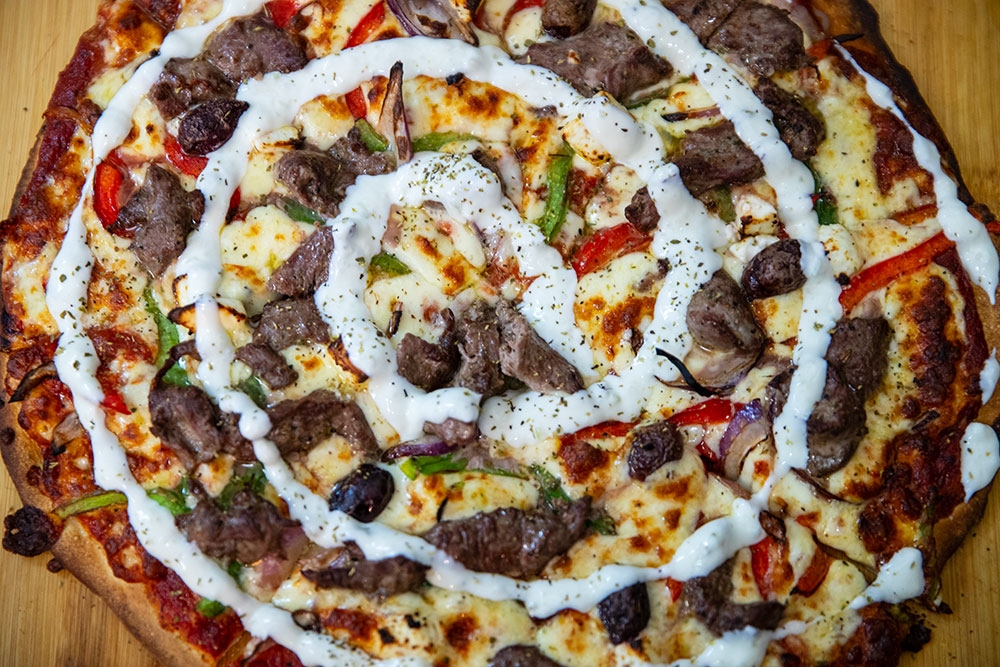 Pizza on plate at Georges Pizza Wine Bar, Burleigh Heads