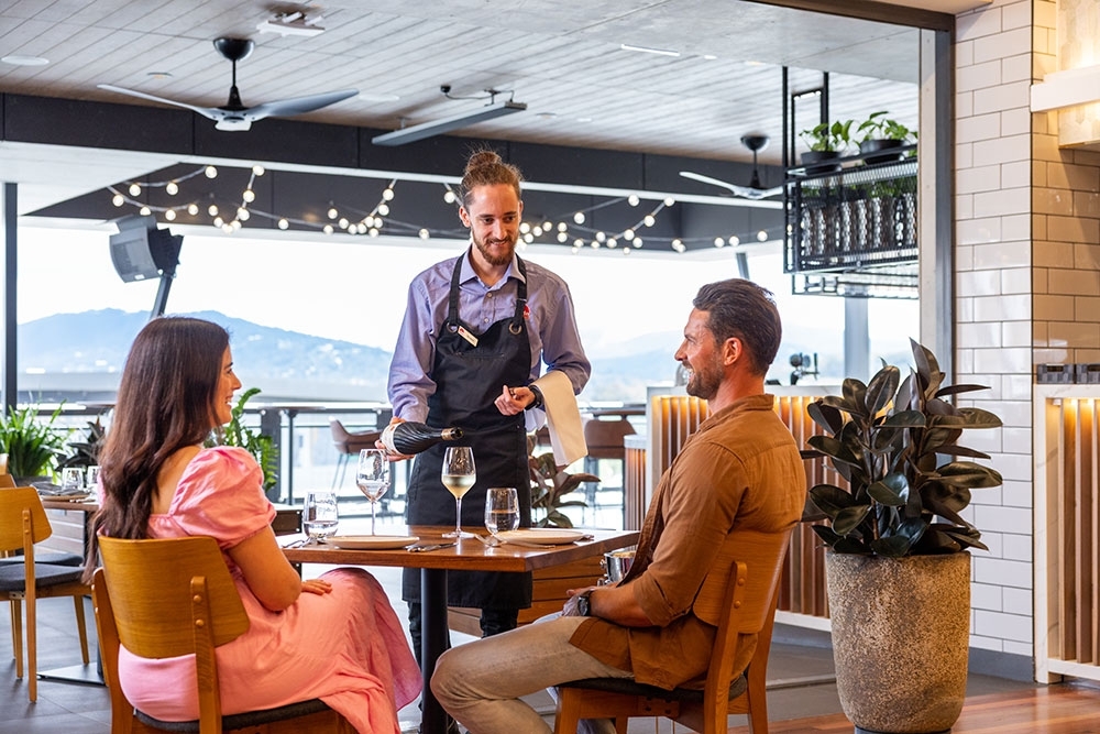 Couple seated on terrace Green Fields Bar + Restaurant