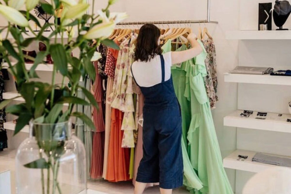 Woman looking at clothes rack in boutique