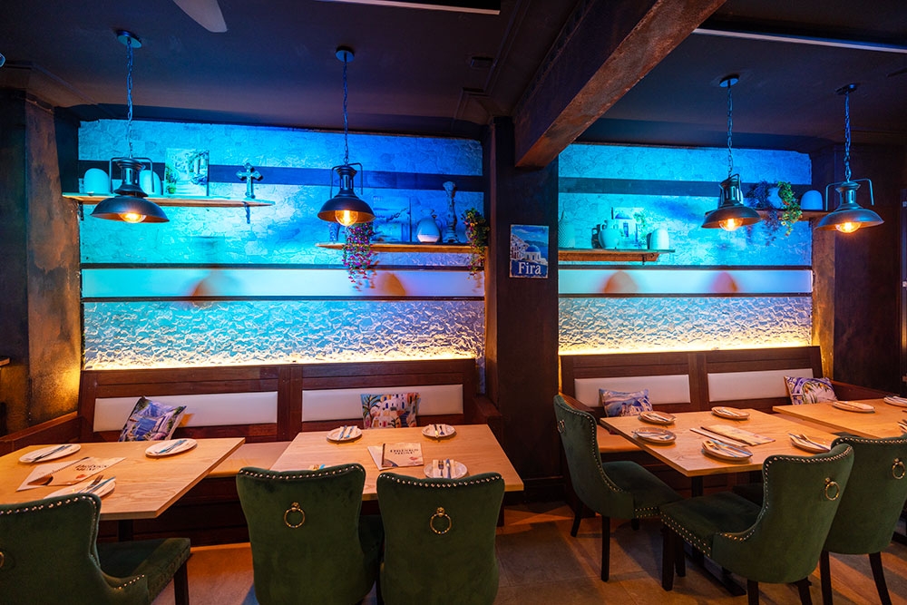 Seating and tables along wall inside La Fira