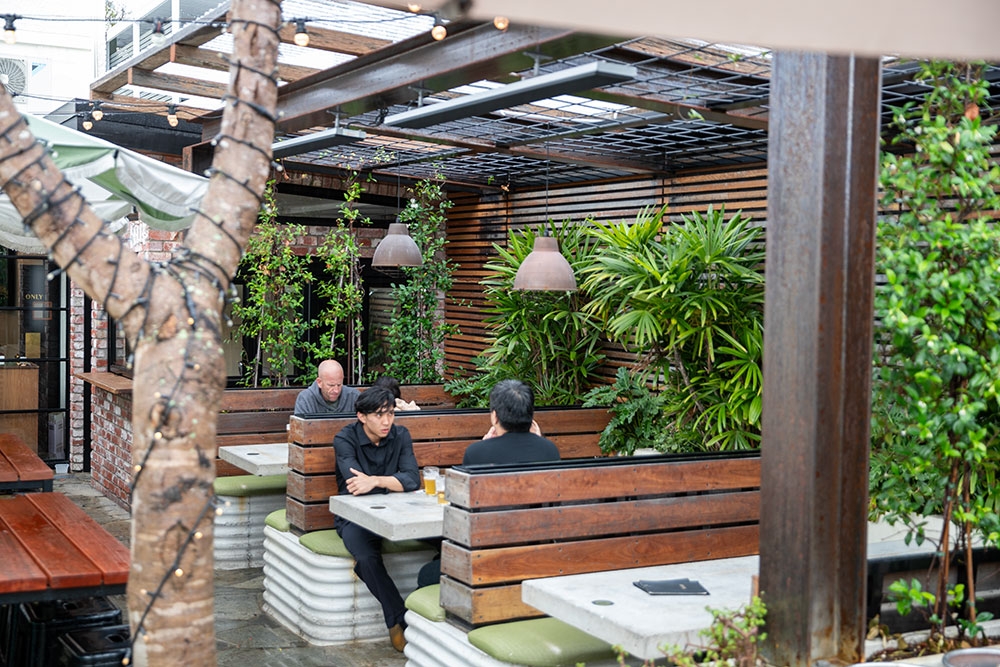 Customer seated in beer garden at Local