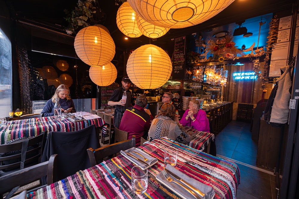 Customers inside Manny's Wine & Fish Burleigh Heads