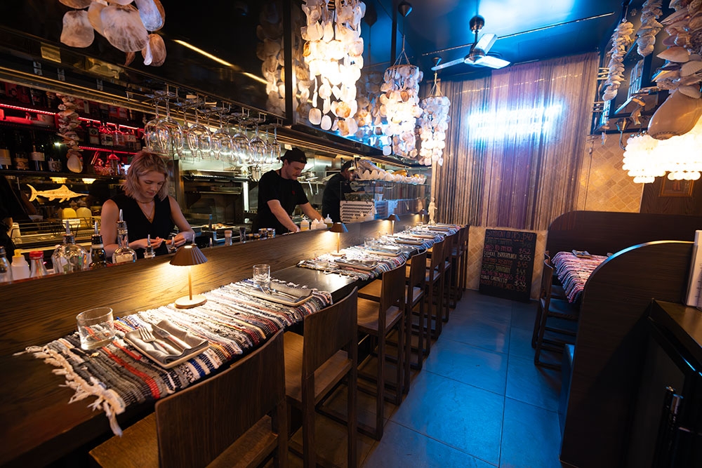 Tables and booth inside Manny's Wine & Fish Burleigh Heads