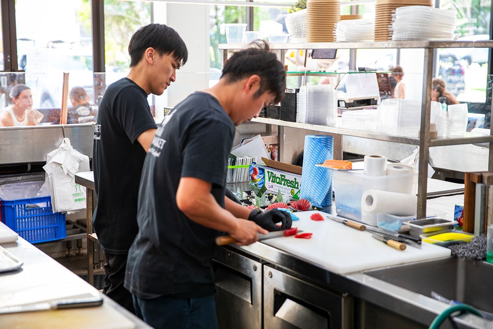 In-house sushi chefs slicing sashimi