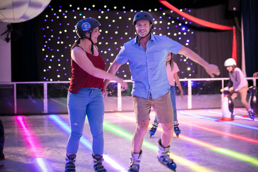 Two people roller skating at Doin’ It for the Kids at Paradise Resort, Surfers Paradise