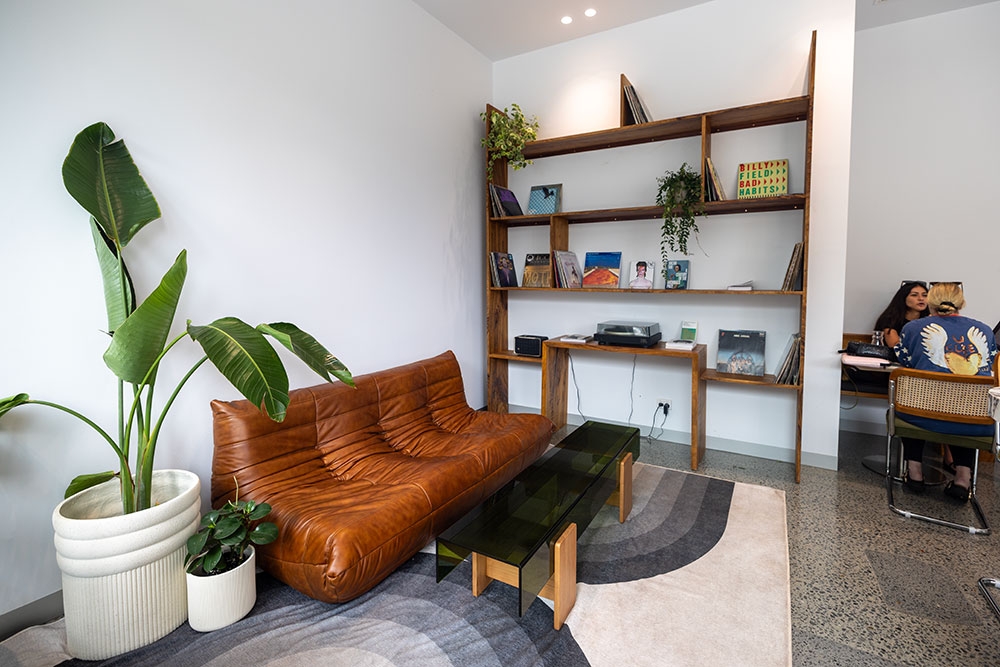Couch and shelves in corner of Sonder