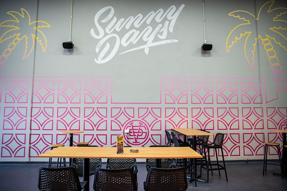 Table against wall inside  Sunny Days Distillery