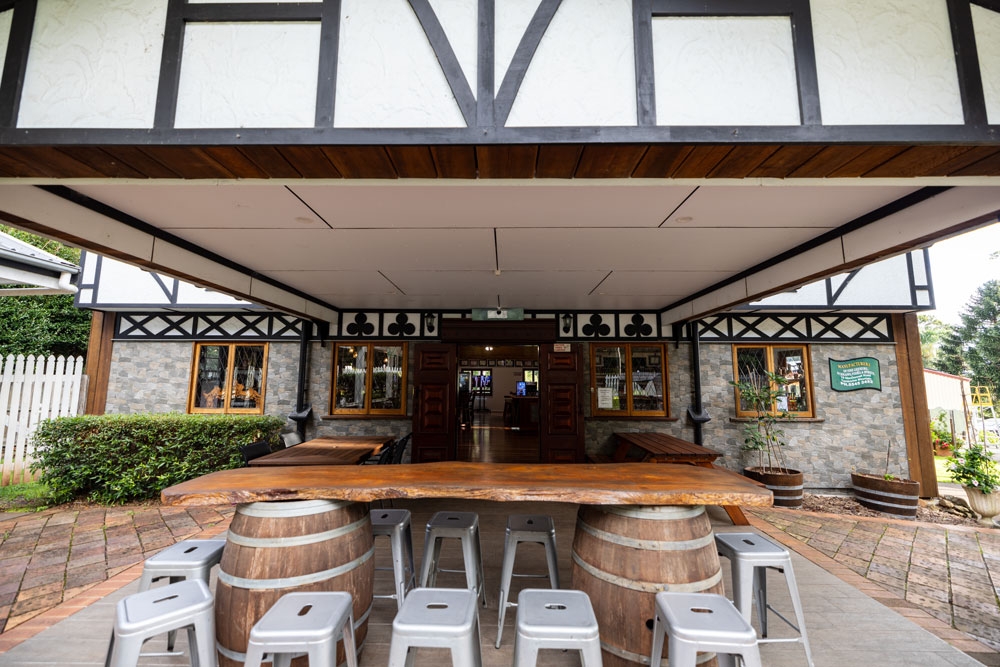 Keg tables and grey plastic stools outside Tamborine Mountain Distillery Tamborine Mountain