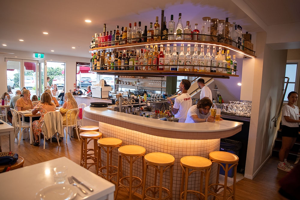 Bar with seating inside Tommy's Italian