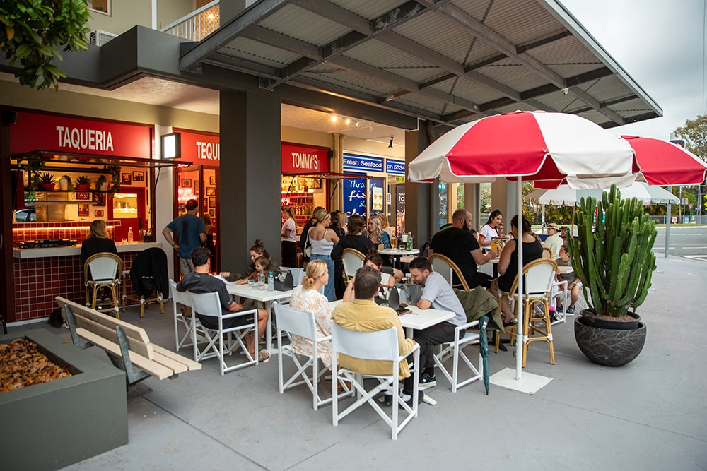 Umbrellas and tables outside Tommy's Taco Bar