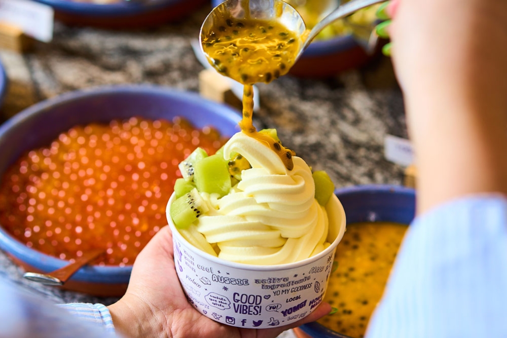 Person scooping yoghurt YOMG