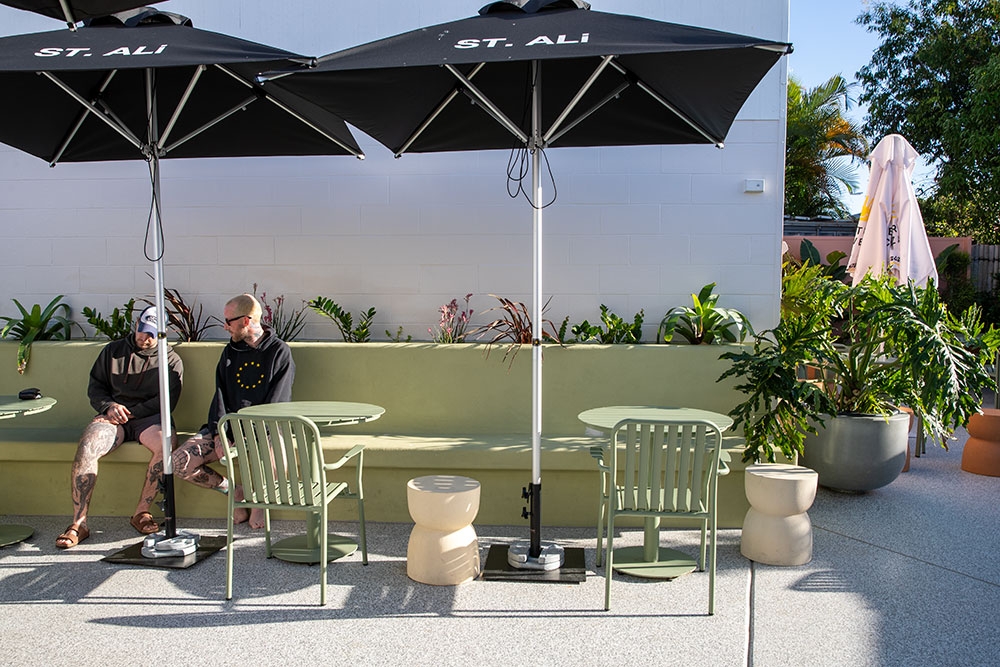 Customers under umbrellas at Home Currumbin Waters