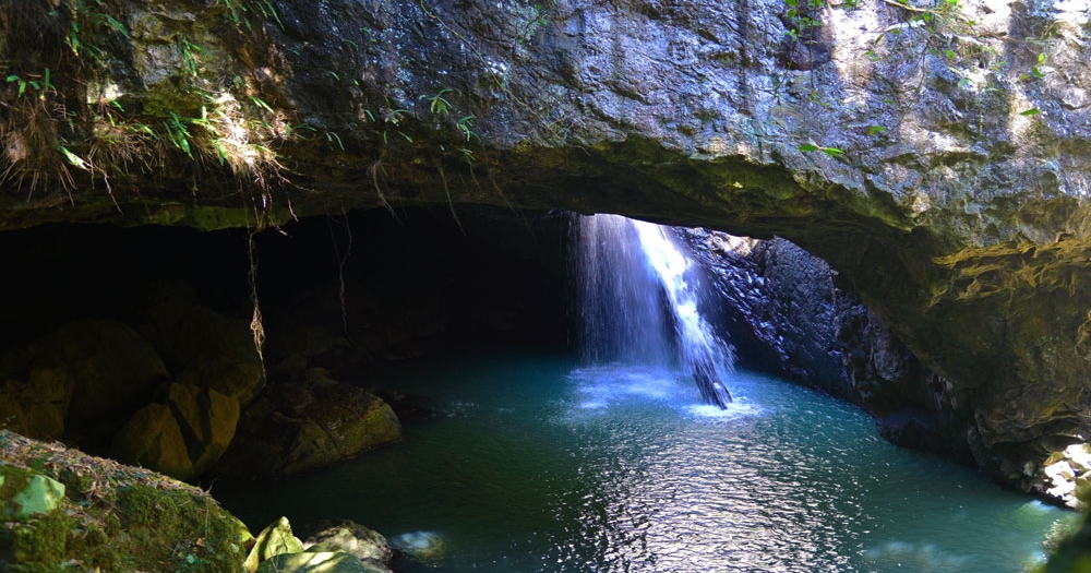Light shining through waterfall cave Natural Bridge